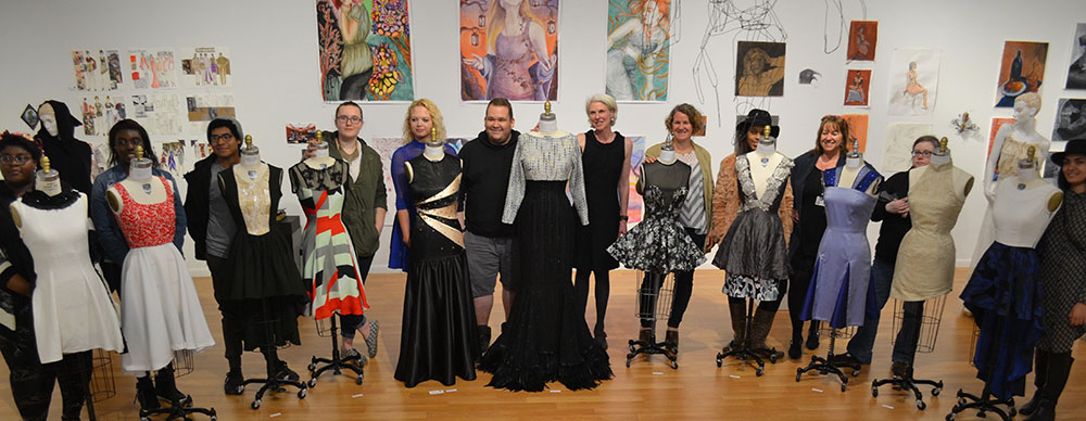 Group shot of Fashion Students with their work in the gallery