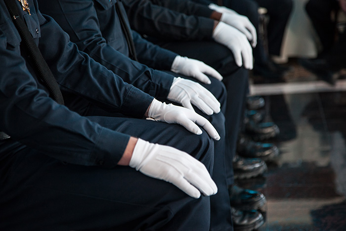 gloved hands on knees at police ceremony
