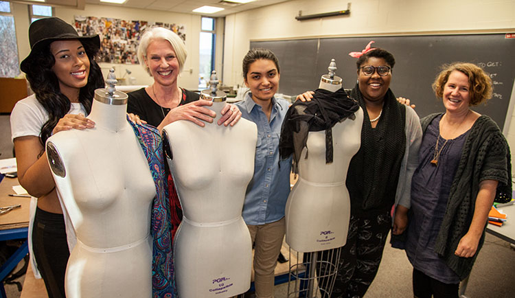 Fashion students  and faculty pose with mannequins