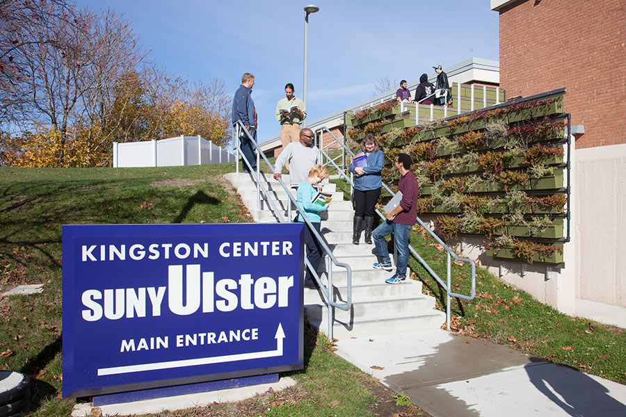 students on stairs near sign for Kingston Center