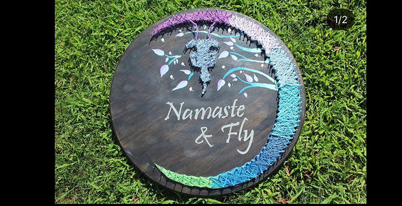 moon piece on wood with text namaste and fly