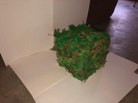 sculpture of a cube made of leaves