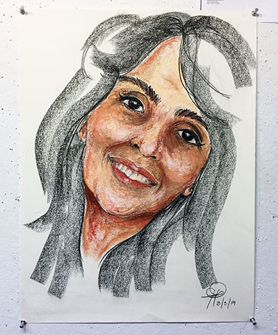 chalk pastel drawing of woman's face, smiling, with head tilted