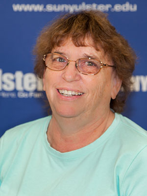 Portrait of Nancy Forsythe in front of SUNY Ulster backdrop