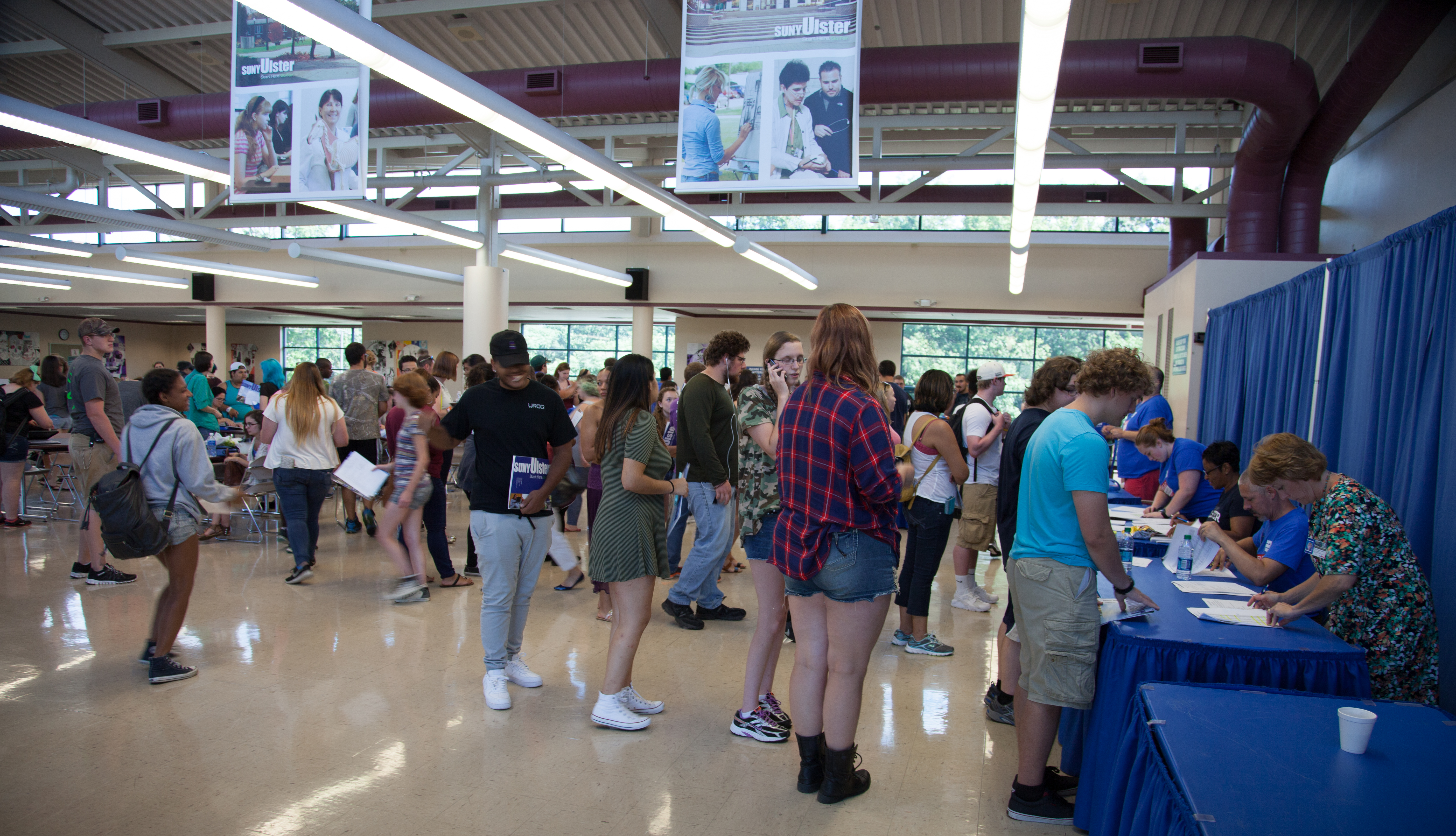 busy dining hall with students waiting in lines