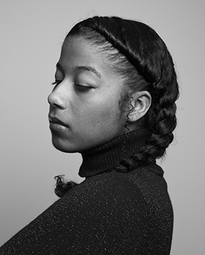 black and white portrait of Aja Monet  with braided hair