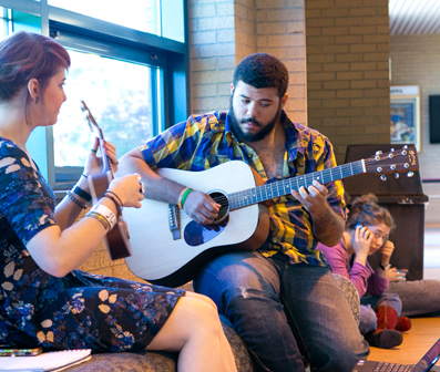 student life center lobby with students playing instruments